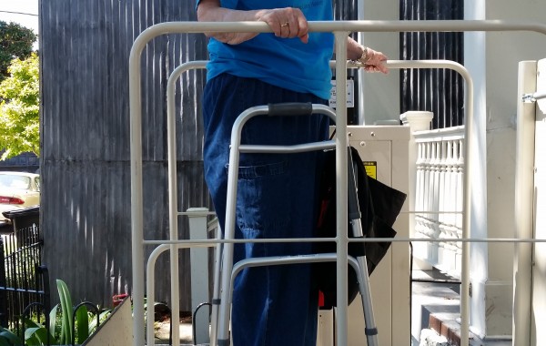 Homeowner riding her Mac's porch lift, available used at Electropedic