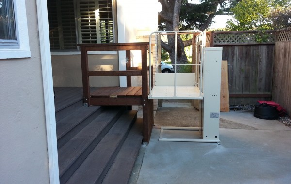 Mac's wheelchair lift at a home entry, available to rent from Electropedic